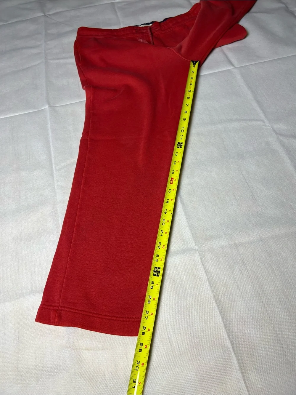 Hollister Co. red sweatpants with white vertical text reading 'HOLLISTER'